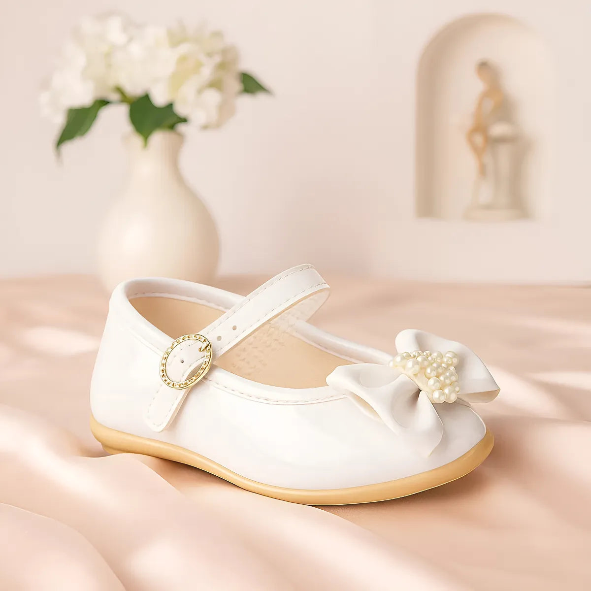 Sapatilha Pimpolho Verniz Branco com Laço e Pérolas – Elegância para os Primeiros Passos